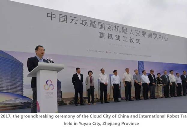 A group of people standing in front of a large white banner Description automatically generated with low confidence