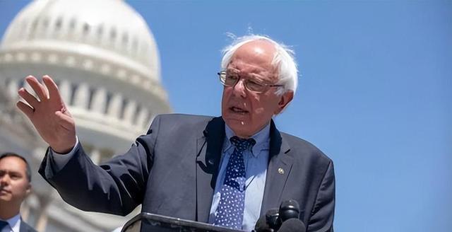 A person in a suit and tie speaking at a podium Description automatically generated